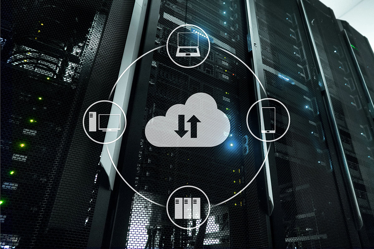 A server room with sleek black racks illuminated by green and blue lights, featuring a central cloud icon with upload and download arrows, surrounded by icons representing a desktop computer, a laptop, and a smartphone.